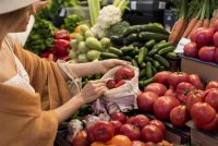 woman-buying-tomatoes-from-market-place © Freepik